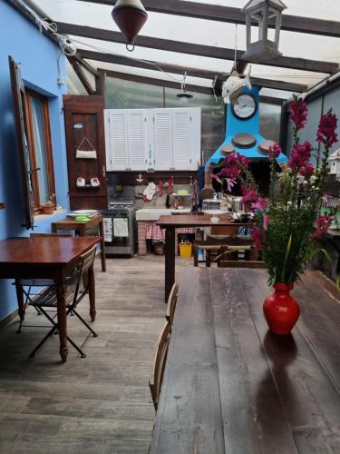 a dining room with a table with a vase of flowers on it at VILLA VILLACOLLE in Procchio