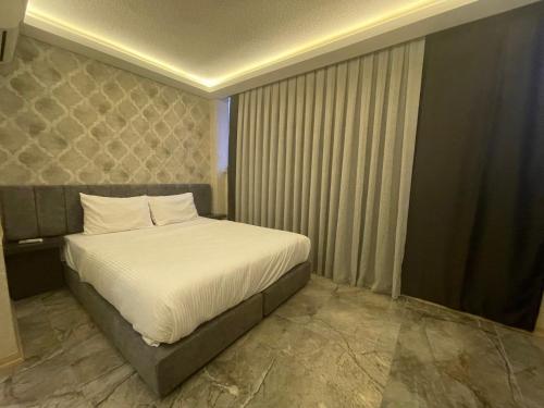 a bedroom with a large bed in a room at Le Luxe Suites Hotel & Spa in Bursa