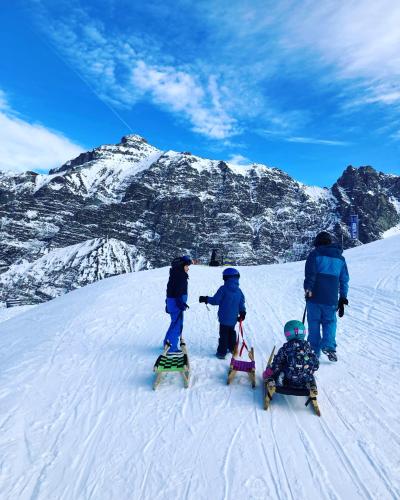 a group of children on skis on a snow covered mountain at Oskar Apartments in Neustift im Stubaital