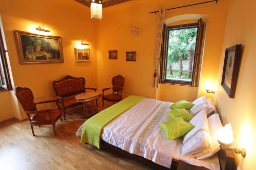 a bedroom with a bed and a table and chairs at Villa Istria in Lovran