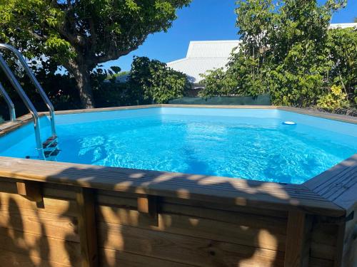 uma piscina com torneira e água azul em Villa Arc-en-ciel em Le Moule