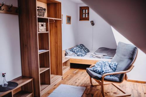 a room with a bed and a chair in a room at Villa Hubertus in Srebrna Góra