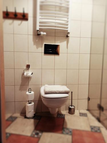 a bathroom with a toilet with a towel on it at Villa Hubertus in Srebrna Góra