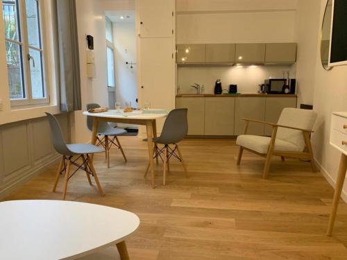 uma sala de estar com mesa e cadeiras e uma cozinha em Les Tiercelines em Dole