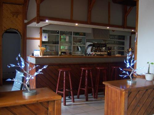 a bar with stools in front of a counter at Hotel Edelweiss in Magland