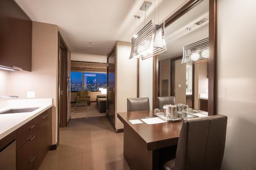 a kitchen and dining room with a table and chairs at StripViewSuites at Vdara in Las Vegas