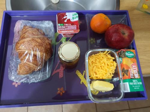 a tray of food with a lunch of bread and cheese at GlassTree B&B in Bredasdorp