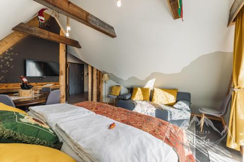 a bedroom with a large bed and a tv at Bajeczna KoJa in Witów