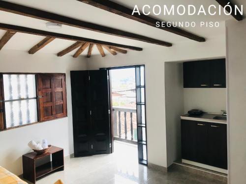 a kitchen with black cabinets and a black door at Hostal Diana in San Agustín
