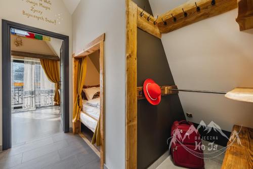 a room with a door leading to a bedroom at Bajeczna KoJa in Witów
