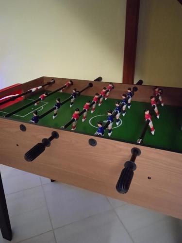 a pool table with a group of people playing a game at Vila Sabo- Casa de vacanta cu lac de pescuit si ciubar cu hidromasaj in Sîntioana