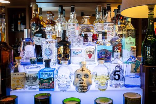 a display of bottles of alcohol on a shelf at Hotel Garni Pegrà in Ponte di Legno