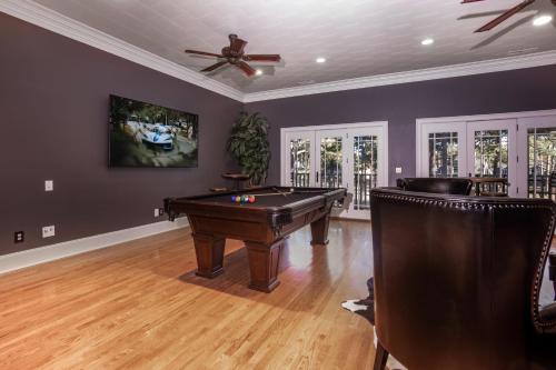 a living room with a pool table and a ceiling fan at New - Spectacular️ Golf Views - Sleeps 20 - Pinehurst National #9 - Near DT Pinehurst! in Pinehurst
