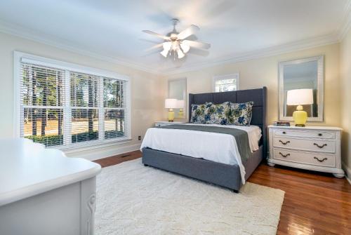 a bedroom with a bed and a ceiling fan at New - Spectacular️ Golf Views - Sleeps 20 - Pinehurst National #9 - Near DT Pinehurst! in Pinehurst