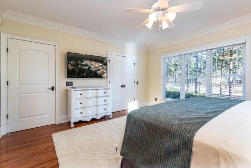 a bedroom with a bed and a ceiling fan at New - Spectacular️ Golf Views - Sleeps 20 - Pinehurst National #9 - Near DT Pinehurst! in Pinehurst