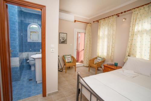 a bedroom with a bed and a bathroom at Private 6-bdrm Villa with garden 150m to beach in Paradisos