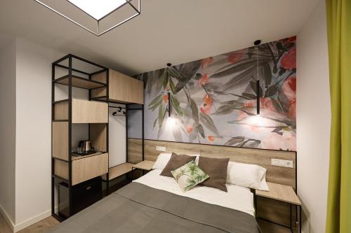 a bedroom with a bed with a painting on the wall at Enmathi Alicante Benalua in Alicante