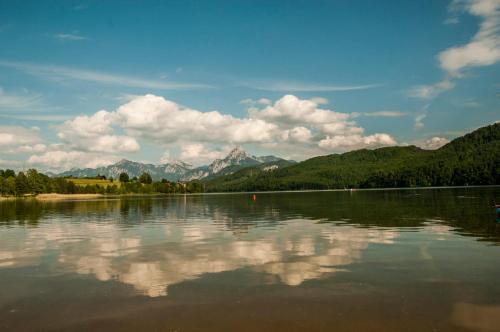 a large body of water with mountains in the background at Allgäu-Moni Trauchgau in Halblech