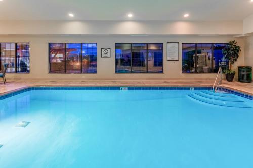 a swimming pool with blue water in a building at Staybridge Suites Davenport, an IHG Hotel in Bettendorf