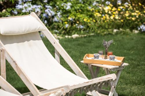 a chair and a table with cups on it at LuCe Design Hotel - Special Category in Alacati