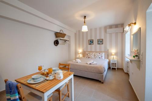 a bedroom with a bed and a table and a bed and a dining room at Sweet Dreams in Gaios