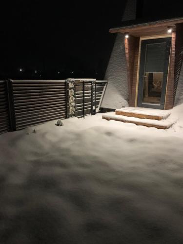 a pile of snow in front of a house at VIP-Domyk in Rakhiv