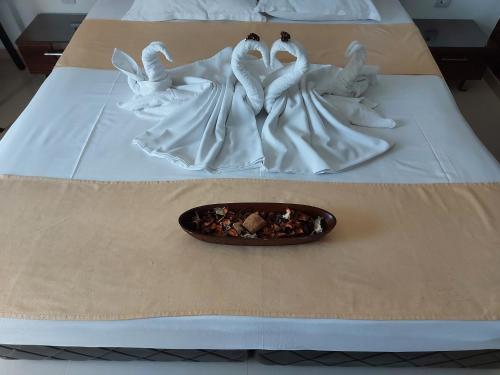 a group of white angel figurines on a bed at Diamond Kiten in Kiten