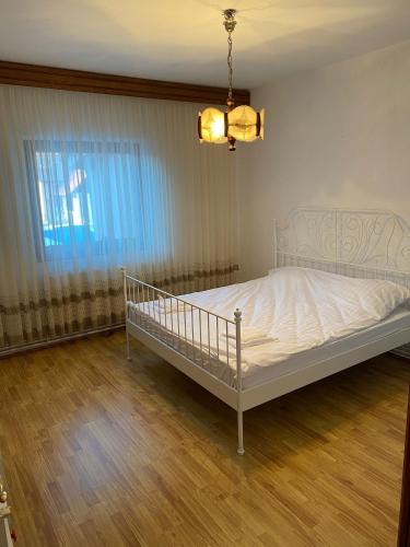 a bedroom with a white bed in a room at Casa Sia in Târgu Ocna