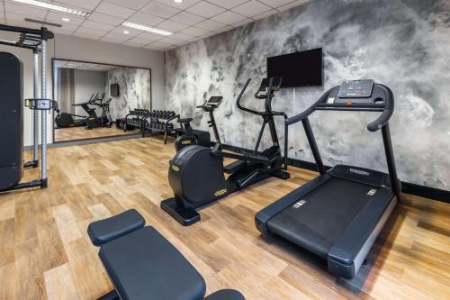 a gym with treadmills and cardio equipment in a room at NH Collection Salzburg City in Salzburg