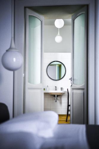 a bedroom with a bed and a mirror and a sink at Camera A Sud in Bovino