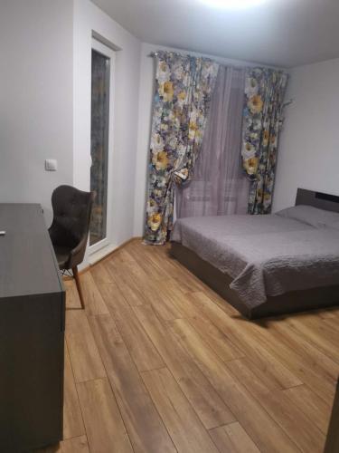 a bedroom with a bed and a desk and a chair at new apartment near city center with free parking in Sofia