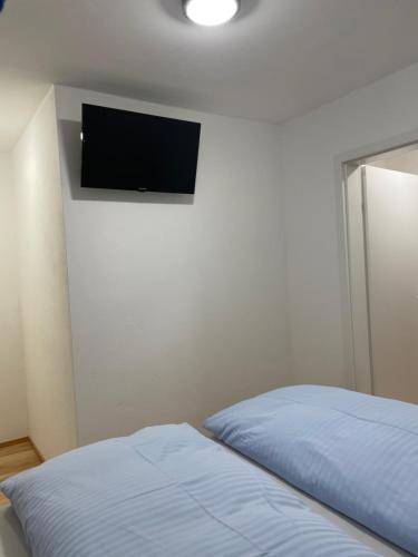 a bedroom with a bed and a television on the wall at Apartment Sabrina in Sankt Johann im Pongau