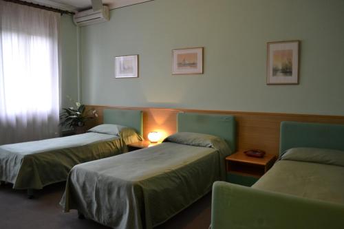 a hospital room with two beds and a window at Hotel Ezzelino in San Zenone