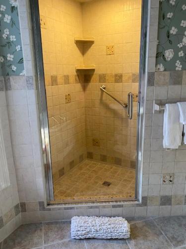 a shower with a glass door in a bathroom at Hanna House Bed & Breakfast in New Bern