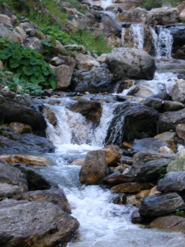 a stream of rushing water in a rocky river at Residenz Scherrhof in Kirchberg in Tirol