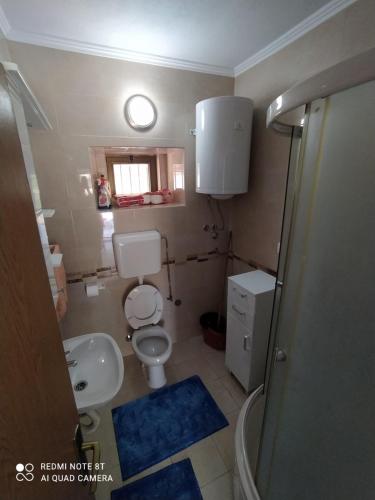 a small bathroom with a toilet and a sink at Vikendica Ćurić in Trebinje