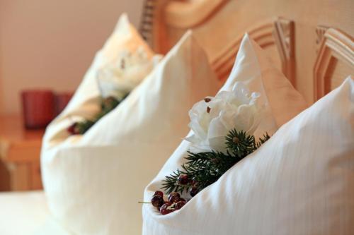 two pillows with flowers in them on a bed at Residenz Scherrhof in Kirchberg in Tirol