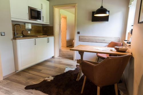 a kitchen with a table and chairs in a room at Alpenchalet Reit im Winkl in Reit im Winkl