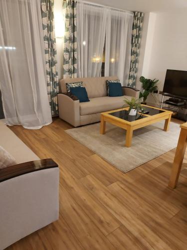 a living room with a couch and a coffee table at Large 2 Bed, 2 Bath, Free Parking & WiFi in Sheffield