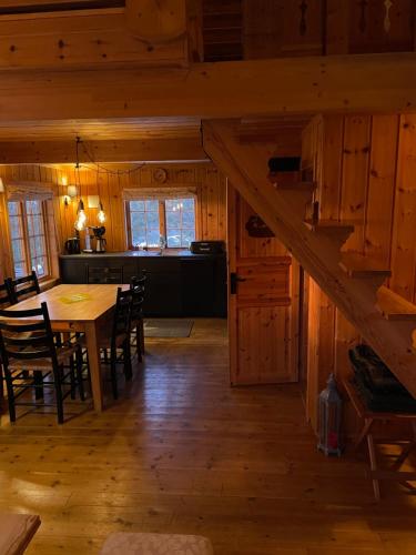 a dining room and kitchen with a table in a cabin at Ski and Bike-In and Out in Hafjell