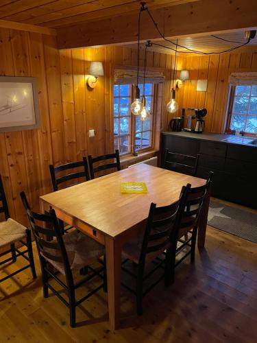 a dining room with a wooden table and chairs at Ski and Bike-In and Out in Hafjell