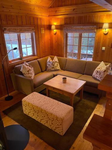 a living room with a couch and a coffee table at Ski and Bike-In and Out in Hafjell
