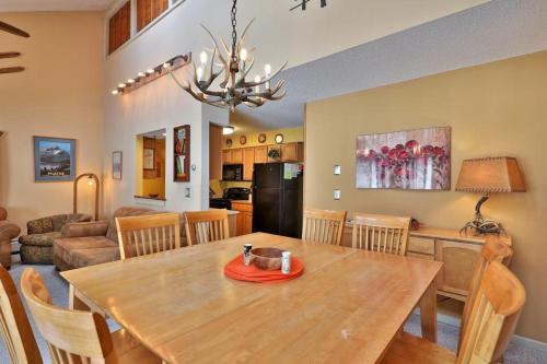 a dining room and living room with a wooden table at Kettle Brook G in Ludlow