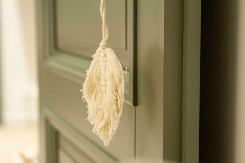 a dried flower hanging from a door handle at Chalet Antoine serviced Apartments by Mirabeau in Zermatt
