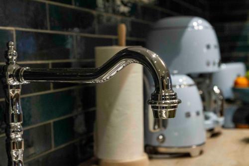 a robot mixer sitting on a counter next to a sink at Chalet Antoine serviced Apartments by Mirabeau in Zermatt