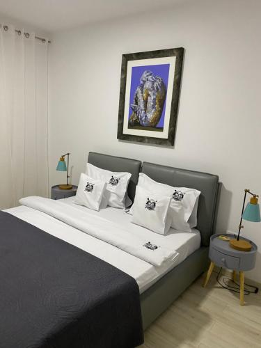 a bedroom with a large bed with white pillows at Lucky Number in Sinaia