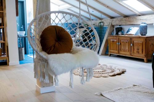 a white chair with icicles on it in a living room at Chalet Antoine serviced Apartments by Mirabeau in Zermatt