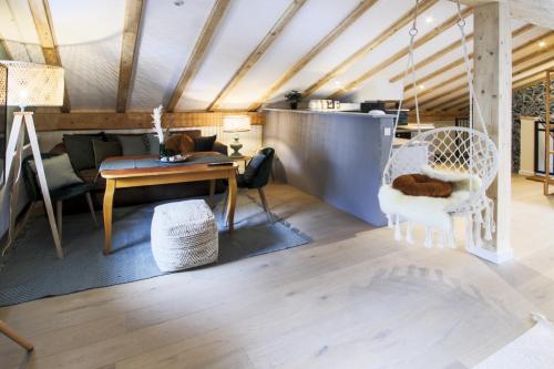 a living room with a table and chairs at Chalet Antoine serviced Apartments by Mirabeau in Zermatt