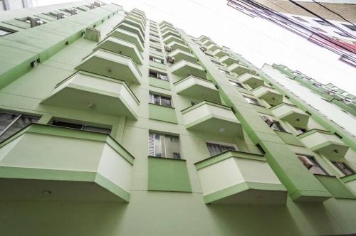 a tall building with balconies on the side of it at Apartamento Quadra Mar Balneário Camboriú in Balneário Camboriú