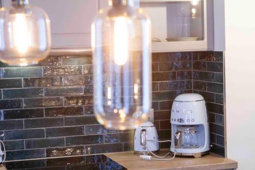 a kitchen with a counter with a toaster and a blender at Chalet Antoine serviced Apartments by Mirabeau in Zermatt